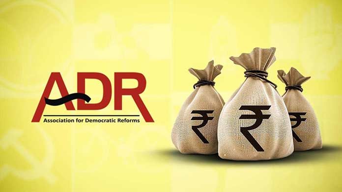 An image with a yellow background featuring the logo of the Association for Democratic Reforms (ADR) on the left side. On the right side, there are three burlap sacks with the Indian Rupee (₹) symbol, tied with black strings, representing money or financial transactions. The image likely signifies political funding, electoral bonds, or financial transparency in democracy.