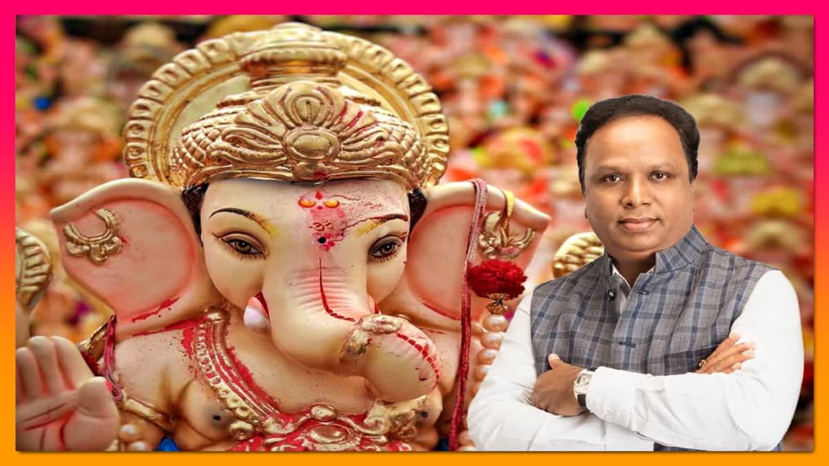 "A digitally edited image featuring a large idol of Lord Ganesha in the foreground, adorned with gold ornaments and red decorations. In the background, numerous other Ganesha idols are visible. To the right, a man in traditional Indian attire with a gray waistcoat and white kurta stands with his arms crossed, looking directly at the viewer. The image has a pink and orange gradient border."
